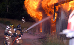 Two firefighters putting out fire
